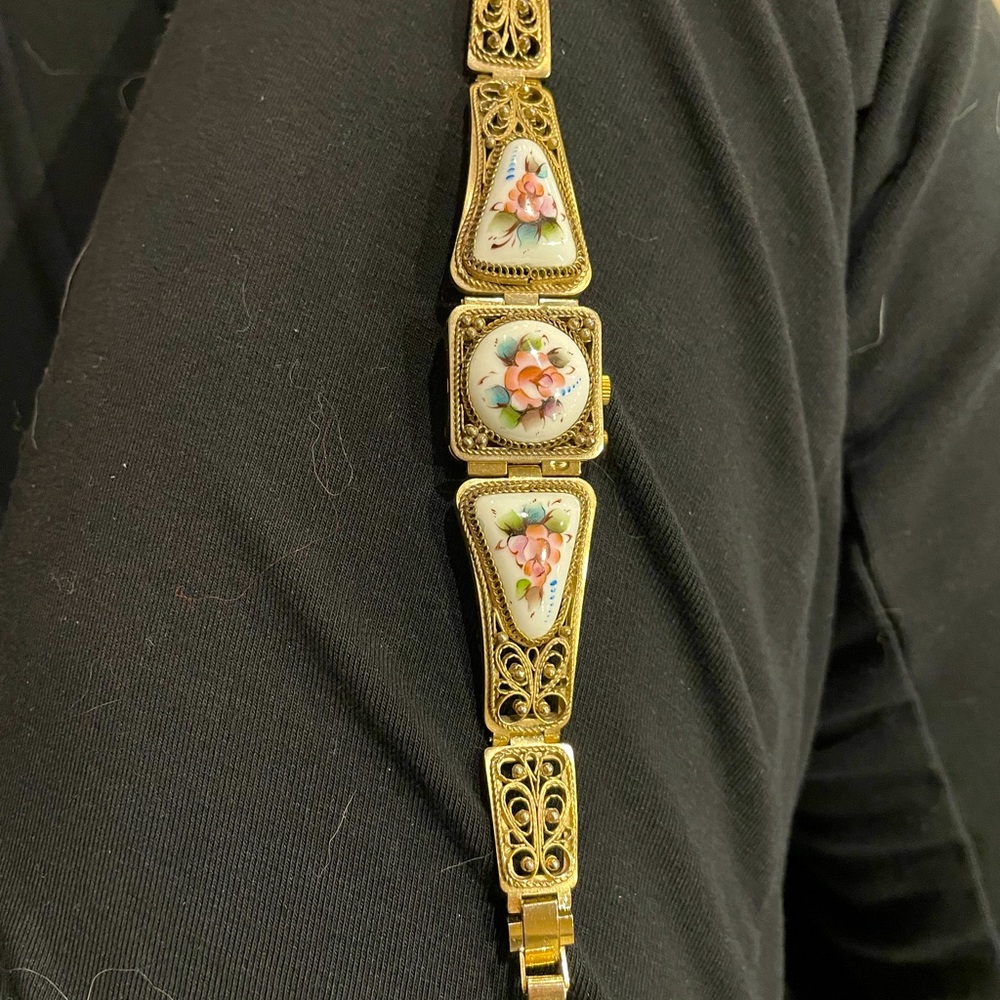 Vintage Russian Yanka watch with floral print on porcelain glass.
